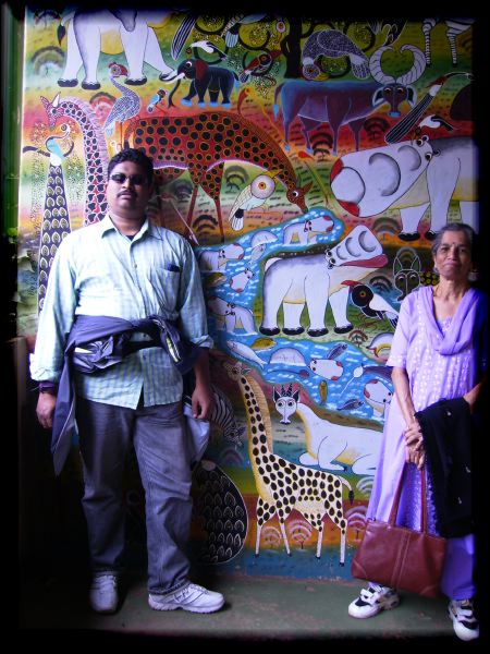 Veena's brother Amar and mom famed against a Tinga Tinga painting